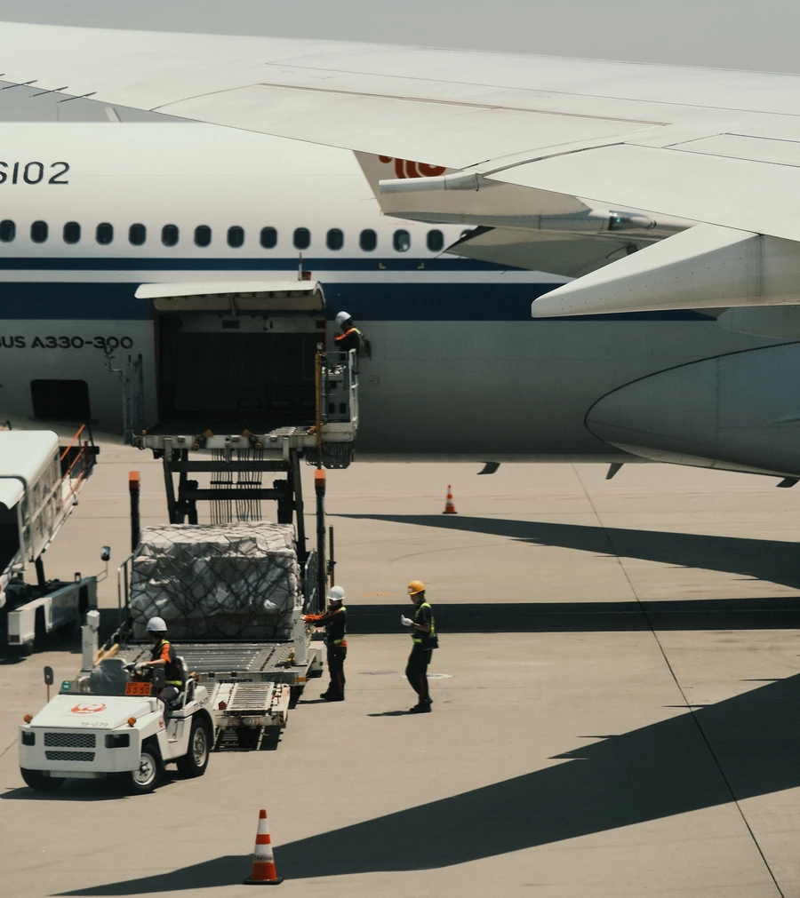 Ground crew loading air cargo onto a passenger aircraft