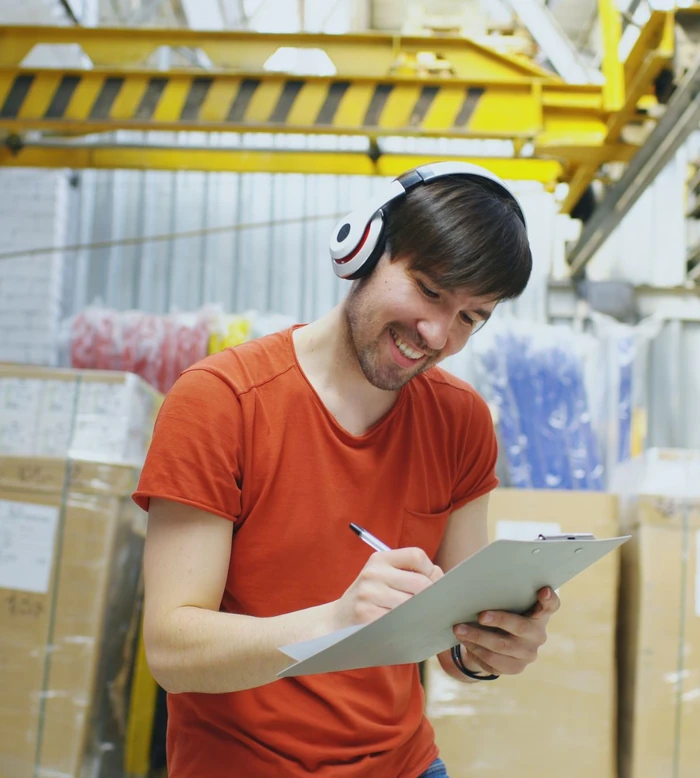 Young warehouse executive checking stock